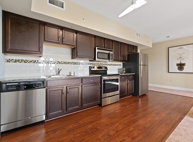 Spacious kitchen with stainless steel appliances and wood cabinets at Market Street Flats